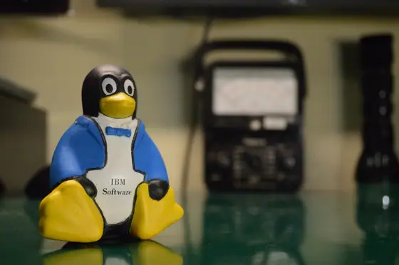 Tux — an IBM Software promo figure on a workbench