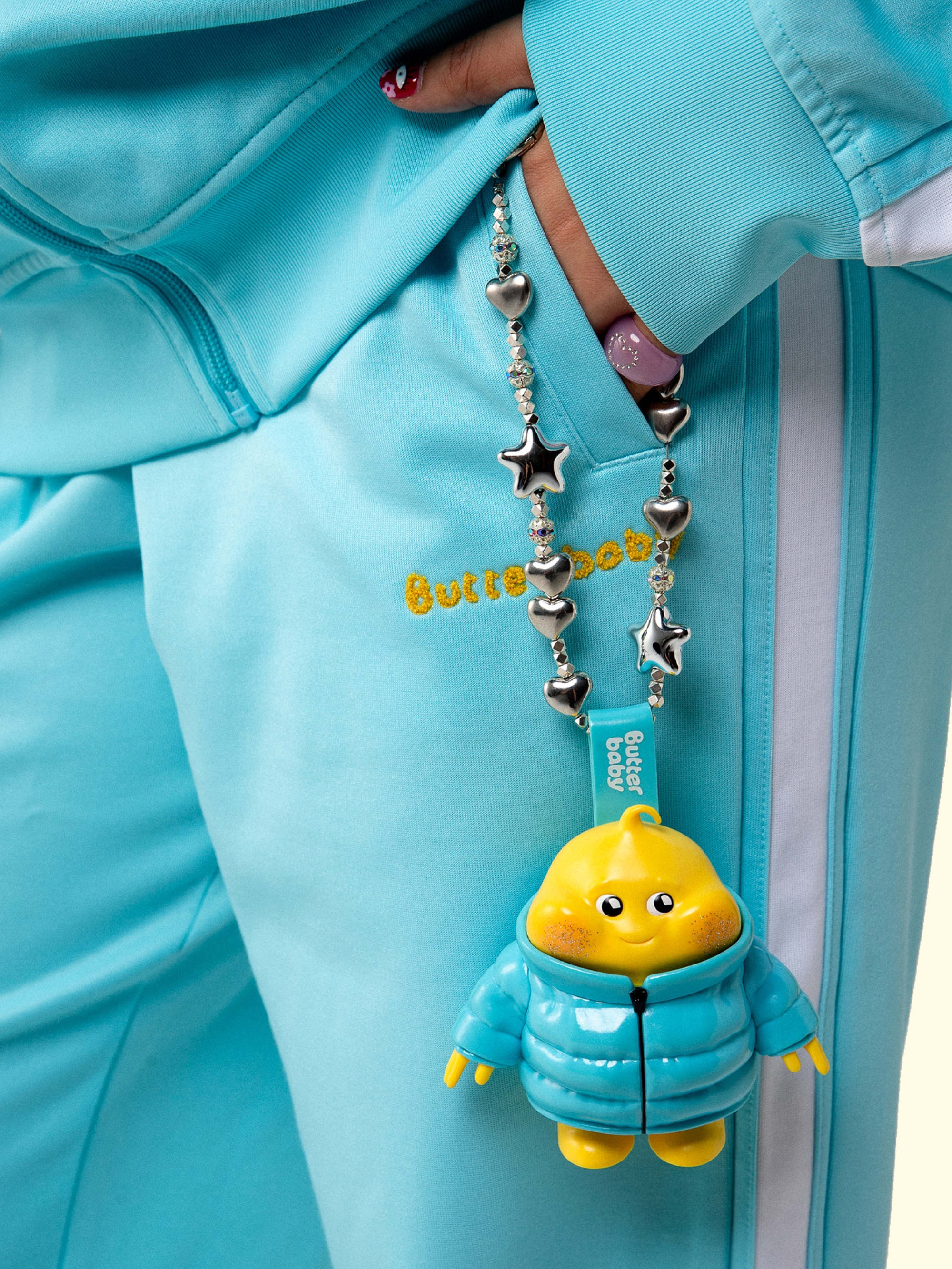 Butter Baby — Puffer-jacket charm, on a bag
